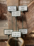 SET OF 6 PAINTED CAST IRON COMICAL PLANT SIGNS STAKES